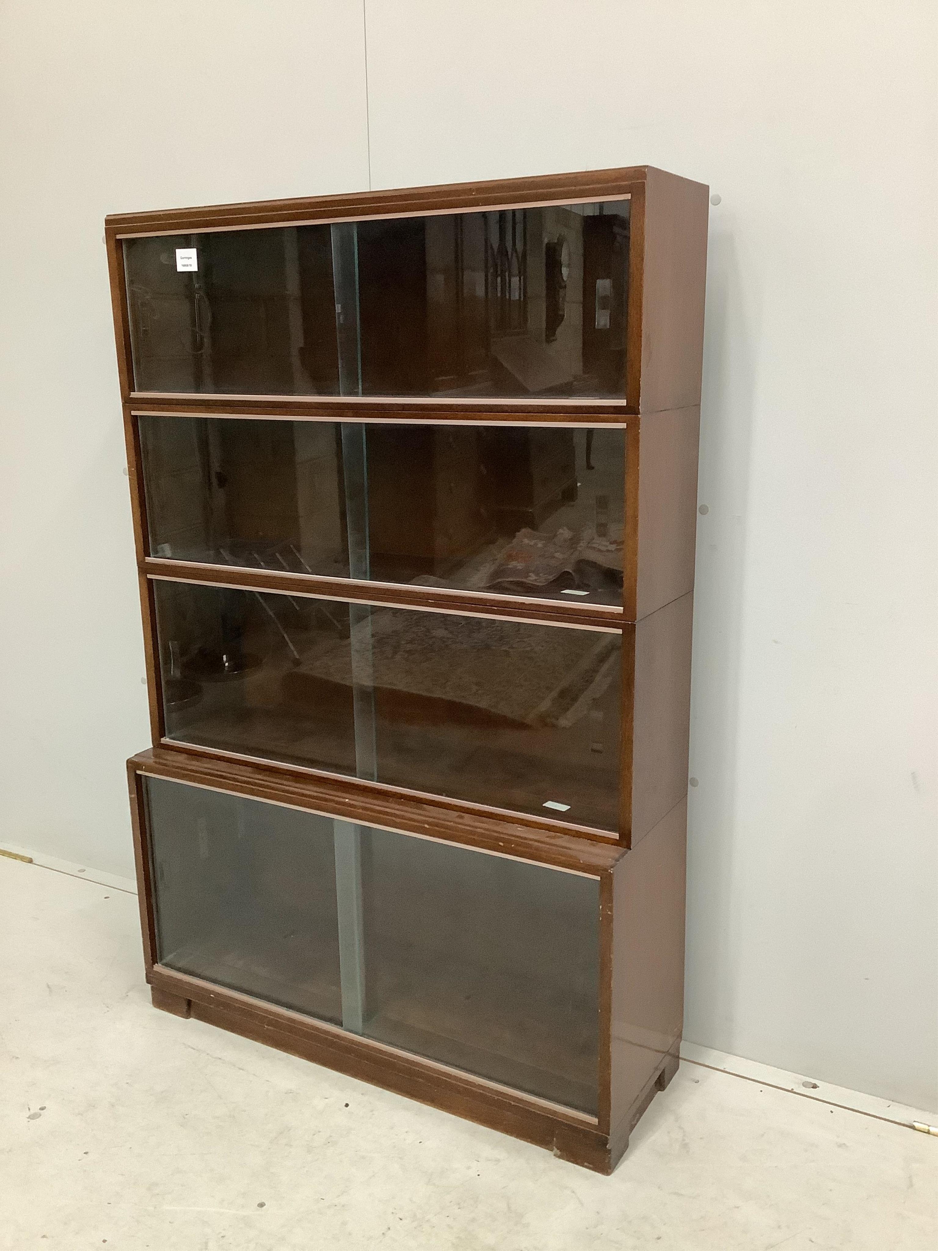 A Minty style mahogany four section bookcase, width 89cm, depth 29cm, height 135cm. Condition - fair to good